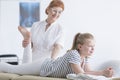 Physiotherapist stretching girl`s leg