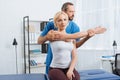 physiotherapist stretching patients arm on massage table Royalty Free Stock Photo