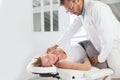 Physiotherapist stretching woman's body