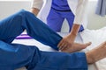 Physiotherapist treating patient at hospital Knee pain in male patient, physiotherapy concept Man Royalty Free Stock Photo