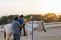 Boy using a ball during an equine therapy session Royalty Free Stock Photo