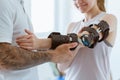 Physiotherapist who puts an orthosis on the hand of a young patient after an accident Royalty Free Stock Photo