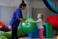 Physiotherapist working with girl with gym ball in rehabilitation center Royalty Free Stock Photo