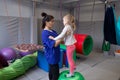 Physiotherapist working with girl with gym ball in rehabilitation center Royalty Free Stock Photo