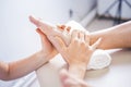 Physiotherapist working with woman giving her massage. Modern rehabilitation physiotherapy. Therapist treating injured legs of ath