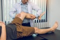 Physiotherapists are using the hands to grip the patient thigh to check for pain and massage in the clinic