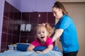 Physiotherapy with child with cerebral palsy. A little girl in clinic lays on the couch