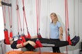 Physiotherapy: Exercise under supervision of physiotherapist. Treatment of pain in the spine with Red Cord equipment Royalty Free Stock Photo