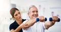Physiotherapy, senior man and dumbbell exercise, injury rehabilitation or workout at health clinic. Happy elderly