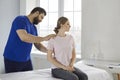 Professional chiropractor or physiotherapist helping patient who& x27;s undergoing rehabilitation