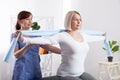 Physiotherapy, sport injury rehabilitation treatment with Resistance Band. Woman having chiropractic back adjustment Royalty Free Stock Photo