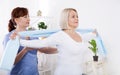 Physiotherapy, sport injury rehabilitation treatment with Resistance Band. Woman having chiropractic back adjustment Royalty Free Stock Photo