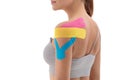 Physiotherapy treatment with therapeutic tape for shoulder pain, aches and tension.