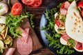 Piadina with mozzarella, tomato, salami slices Royalty Free Stock Photo