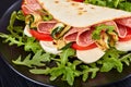 Piadina with mozzarella, tomato, salami, zucchini Royalty Free Stock Photo