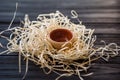 Piala in straw nest on wooden desk