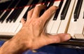 Pianist hand playing a chord.