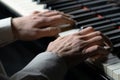 Pianist man plays music on the piano. Musician touches the white and black keys of string instrument with his fingers Royalty Free Stock Photo