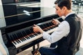 Pianist opens the keyboard lid of grand piano Royalty Free Stock Photo