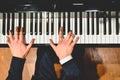 Pianist performing a piece on a grand piano with white and black keys., Seen from above Royalty Free Stock Photo