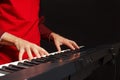 Pianist play the keys of the digital piano on black background Royalty Free Stock Photo