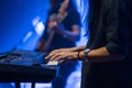 Pianist playing electric piano in concert, music concept.