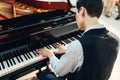 Pianist playing music on grand piano