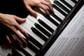 Pianist playing piano music on electrical keyboard, on black background Royalty Free Stock Photo