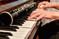 The pianist plays the white piano keys, the clarinet lies nearby Royalty Free Stock Photo