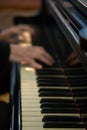 Pianist\'s hands in close-up while playing the piano. Piano keys during a classical music concert Royalty Free Stock Photo