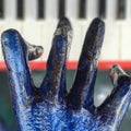 A blue statue hand gets ready to tickle the ivory - PIANO - ART - MUSIC