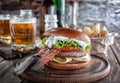 Piano burger with bacon and cutlet with cheese, tomato, greens.