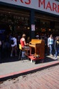 Piano busker entertains visitors