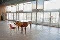 Piano and chair in otherwise empty `Achilles Mussche` concert hall