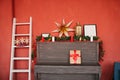 A piano with Christmas decorations on it and a white staircase in the house