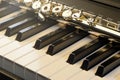 Piano and flute with golden shine and sheet music. Horizontal Composition.Front view Royalty Free Stock Photo