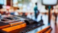 Piano keyboard close-up with a blurred people on event background. Promotion of offline music concerts