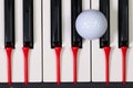 Piano keyboard and different golf balls and tees Royalty Free Stock Photo