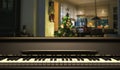 Piano keyboard, front view, blur christmas tree background. 3d illustration