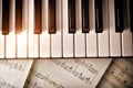 Piano keyboard with golden shine and sheet music top view Royalty Free Stock Photo