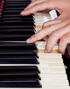Piano keyboard made of ivory with hands Royalty Free Stock Photo