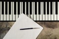 Piano keyboard, pen and blank paper. The concept of composing music, songs, creativity, learning Royalty Free Stock Photo