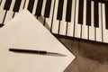 Piano keyboard, pen and blank paper. The concept of composing music, songs, creativity, learning Royalty Free Stock Photo