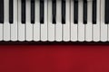 Piano keyboard on a red background Royalty Free Stock Photo