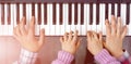 Piano Keyboard top View and Hands of Child Mother and Father