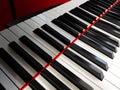 The piano keys. Black and white keys with red detail. Royalty Free Stock Photo