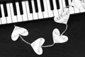 Piano keys and hearts of the music on a black background