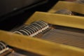 Piano mechanism. Inside of grand piano. Close-up view of hammers, strings inside the piano.