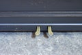 Piano pedals. Old-fashioned antique ornamental piano with carved pillars