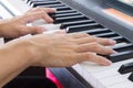 Piano Player Hand on Electric Piano in Crosswise View Royalty Free Stock Photo